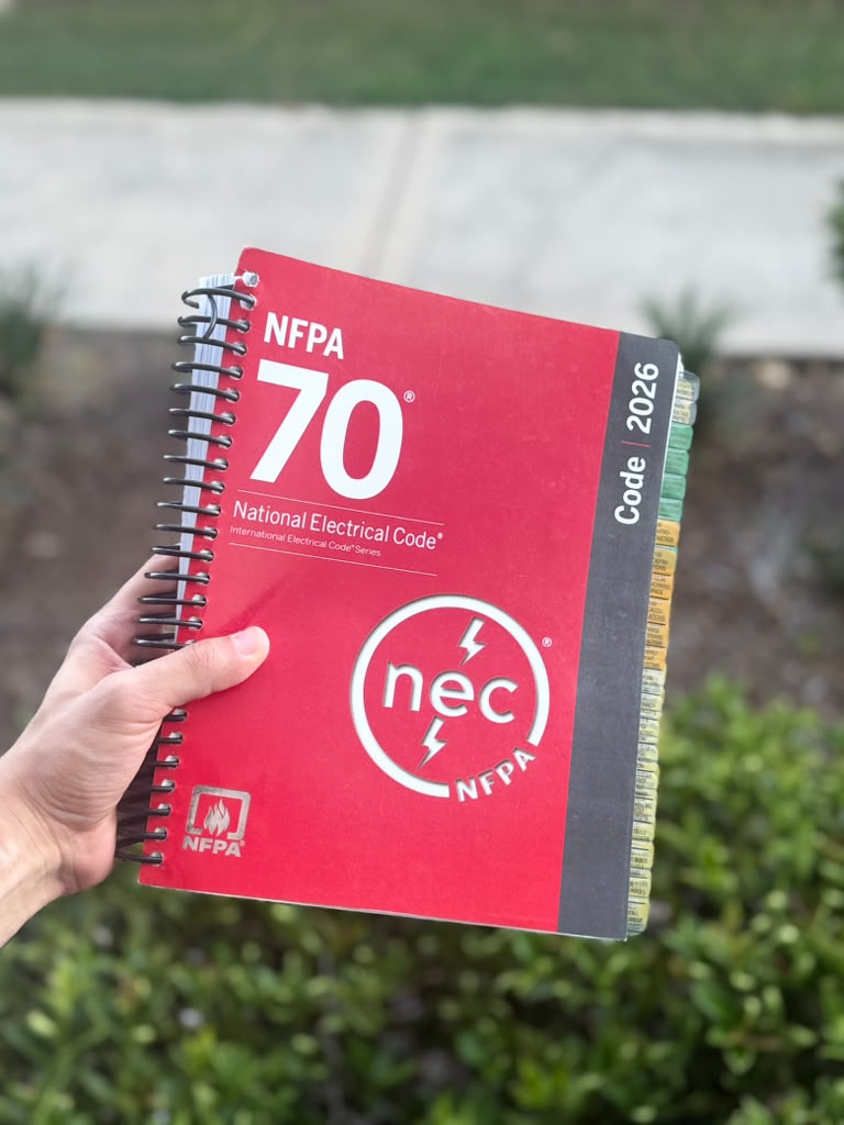 Tabbed NEC 2026 Spiralbound codebook open to article, ready for electrician exam